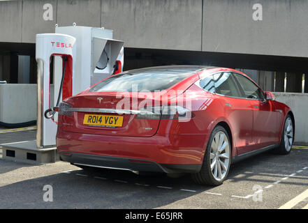Tesla Model S electric super car charging at a Supercharger station ...