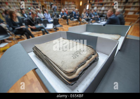 Weimar, Germany. 15th Aug, 2014. The re-discovered first edition of Nicolaus Copernicus' 'De revolutionibus orbium coelestium, Libri VI' from 1543 in the student center of the Duchess Anna Amalia Library in Weimar, Germany, 15 August 2014. The volume was severely damaged during the fire in the library on 02 September 2004 and will be restored in the foundation's special workshop in Legefeld. Photo: CANDY WELZ/dpa/Alamy Live News Stock Photo