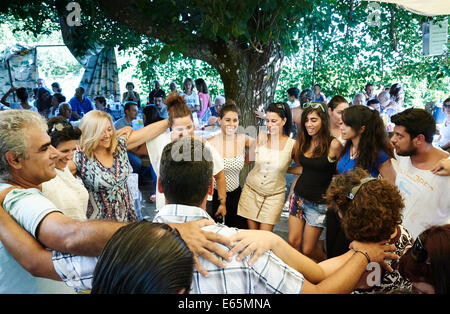 Ikaria island, Greece. 15th August 2014. Villagers dance the local dance, the Ikariotiko, at a panegyri, a celebration of the Feast of the Assumption of the Virgin Mary. Credit:  Edward Webb/Alamy Live News Stock Photo