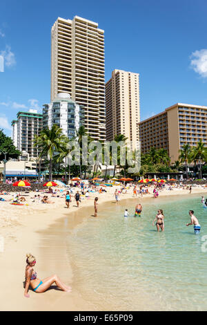 Honolulu Hawaii,Oahu,Hawaiian,Waikiki Beach,resort,Kuhio Beach State Park,Pacific Ocean,sunbathers,families,crowded,high rise,buildings,hotel,condomin Stock Photo