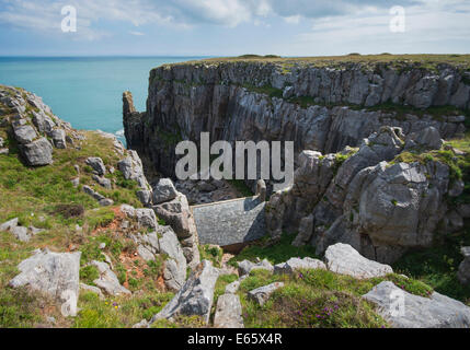 St Govan's Chapel nestled into the cliffs at St Govan's Head on the coast of Pembrokeshire in South Wales. Stock Photo
