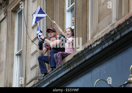 Glasgow, Scotland, UK, Friday, 15th Aug, 2014. Supporters of Team Scotland watch from the first floor of a tenement as the Athletes take part in a parade to the city centre to thank the public for their support during the Glasgow 2014 Commonwealth Games Stock Photo