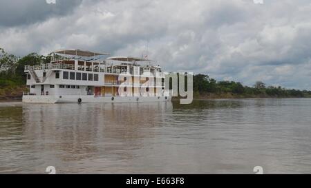 The Queen Violeta cruise ship sails down the Amazon River near Iquitos, Peru Stock Photo