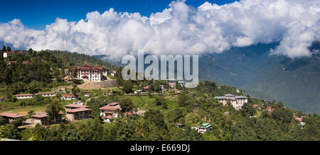 Eastern Bhutan, Mongar, panoramic view across town to Dzong with cloud over surrounding hills Stock Photo