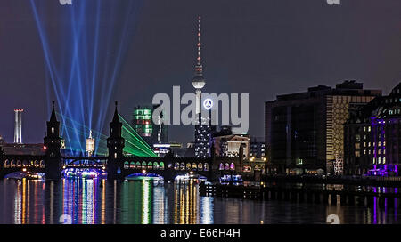 Berlin, Germany. 15th Aug, 2014. Lit-up tour boats on the Spree in the East Harbour in Berlin, Germany, 15 August 2014. The occasion is Aquarella Berlin which takes place onm 16 anbd 29/30 August. Photo: PAUL ZINKEN/dpa/Alamy Live News Stock Photo