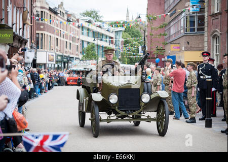 High Street, Worcester, UK. 16th August 2014. First World War and contemporary weapons gave the salute at Worcester Racecourse as one of the highlights of the Artillery special day, which marks the 150th anniversary of the city's local Army Reserve unit, 214 (Worcestershire) Battery Royal Artillery.  Pictured: An historic military vehicle passes Worcester's Guildhall in the High Street as part of the city's Artillery Day celebrations. Credit:  Lee Thomas/Alamy Live News Stock Photo