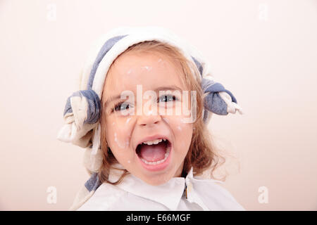 beautiful little girl painting and smiling Stock Photo