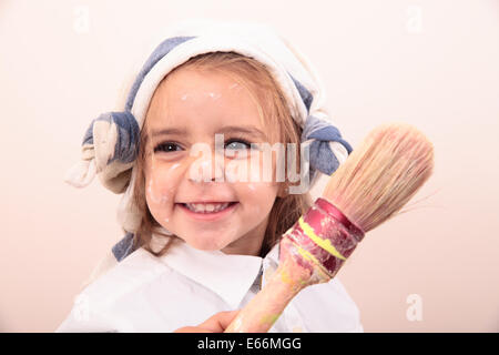 beautiful little girl painting and smiling Stock Photo