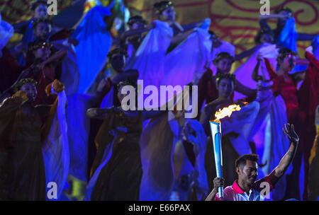 Nanjing. 16th Aug, 2014. Chinese badminton player Lin Dan runs with torch at the Opening Ceremony of the Nanjing 2014 Youth Olympic Games in Nanjing, capital of east China's Jiangsu Province. Credit:  Purbu Zhaxi/Xinhua/Alamy Live News Stock Photo