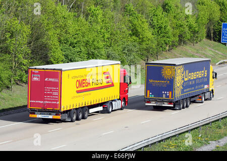 Two articulated trucks traveling along the M20 motorway in Kent, England Stock Photo