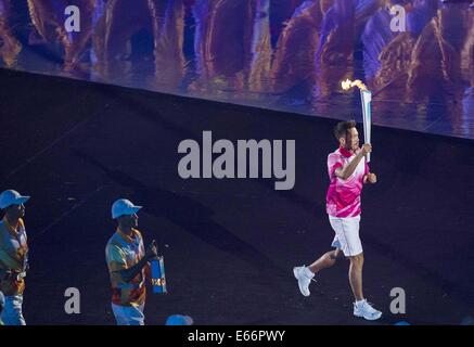 Nanjing. 16th Aug, 2014. Chinese badminton player Lin Dan runs with torch at the Opening Ceremony of the Nanjing 2014 Youth Olympic Games in Nanjing, capital of east China's Jiangsu Province. Credit:  Chen Cheng/Xinhua/Alamy Live News Stock Photo