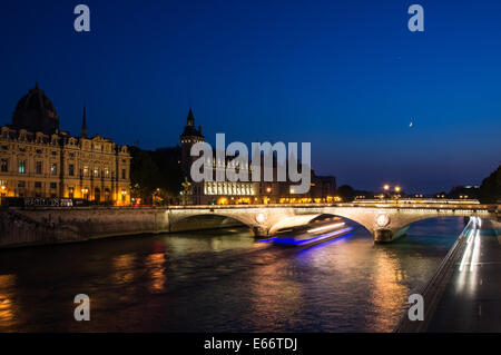 The Pont au Change, bridge over river Seine and the Conciergerie at dusk, Paris, France Stock Photo