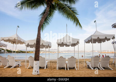 Beach chairs and palm at the Las Hadas Resort in Manzanillo, Colima. Stock Photo