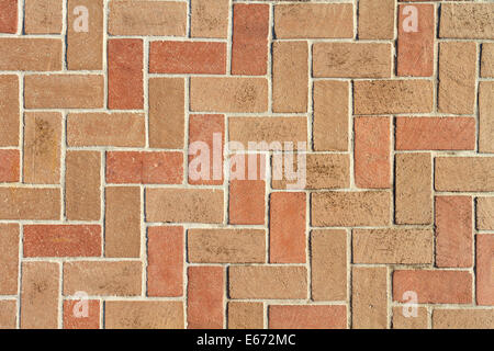 A red and brown clay brick pavers walkway or driveway background texture in a Herringbone 90 degree pattern. Non-seamless. Stock Photo
