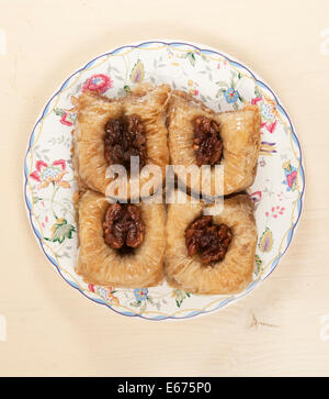 Baklava with walnut 'Sultan' on a plate and light table Stock Photo