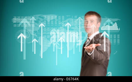 Businessman with graphs and arrows Stock Photo