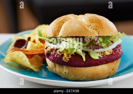 Beetroot burger on white bread with chips Stock Photo
