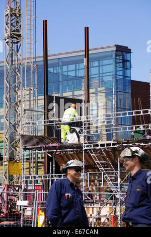 two building workers with construction site in background Stock Photo