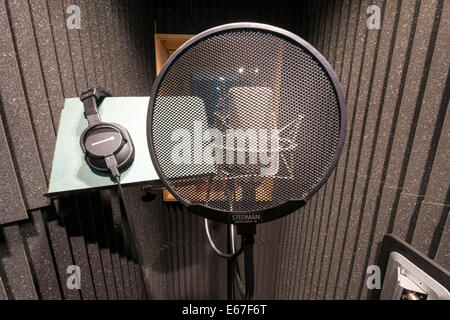 A neuman microphone in a vocal booth in a music recording studio with a pop shield in front Stock Photo