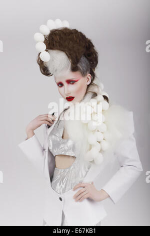 Haute Couture. Extravagant Woman in Cyber Costume and Theatrical Hair-do Stock Photo