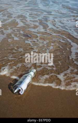 Message in a bottle on a sandy beach Stock Photo