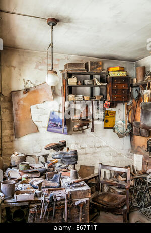 A Traditional Cobblers work shop, with many work tools, at the Blists hill Victorian Town museum, Telford, Shropshire England Stock Photo