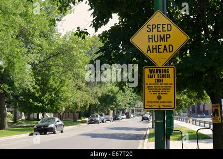 Speed hump ahead and safe school zone warning sign, Chicago, Illinois. Stock Photo