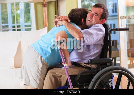 Couple with Cerebral Palsy hugging in their home Stock Photo