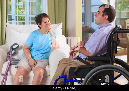 Couple with Cerebral Palsy talking in their home Stock Photo