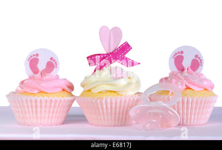Three pink theme baby girl cupcakes with dummy pacifier against a white background for baby shower or new born nursery greeting Stock Photo