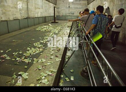 Beijing, China. 14th Aug, 2014. AUGUST 14: People throw small change to the coffin bed as they pray for a better future at the underground palace of Dingling Tomb, the mausoleum of Emperor Zhu Yijun (1563 - 1620) of Ming Dynasty, on August 14, 2014 in Beijing, China. © SIPA Asia/ZUMA Wire/Alamy Live News Stock Photo