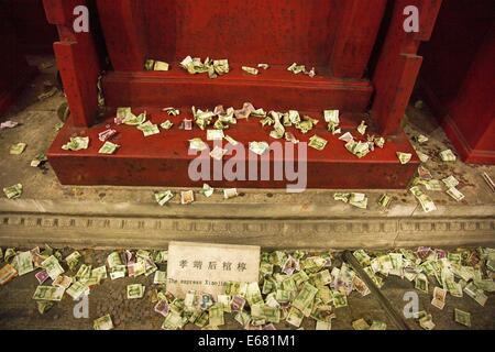 Beijing, China. 14th Aug, 2014. AUGUST 14: People throw small change to the coffin bed as they pray for a better future at the underground palace of Dingling Tomb, the mausoleum of Emperor Zhu Yijun (1563 - 1620) of Ming Dynasty, on August 14, 2014 in Beijing, China. © SIPA Asia/ZUMA Wire/Alamy Live News Stock Photo