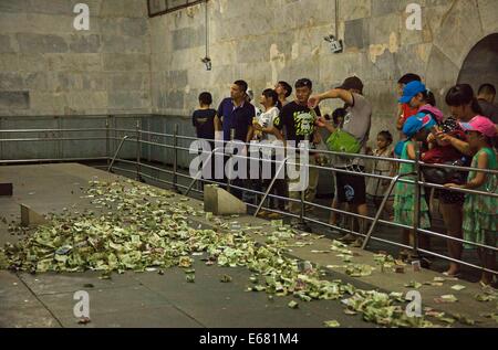 Beijing, China. 14th Aug, 2014. AUGUST 14: People throw small change to the coffin bed as they pray for a better future at the underground palace of Dingling Tomb, the mausoleum of Emperor Zhu Yijun (1563 - 1620) of Ming Dynasty, on August 14, 2014 in Beijing, China. © SIPA Asia/ZUMA Wire/Alamy Live News Stock Photo