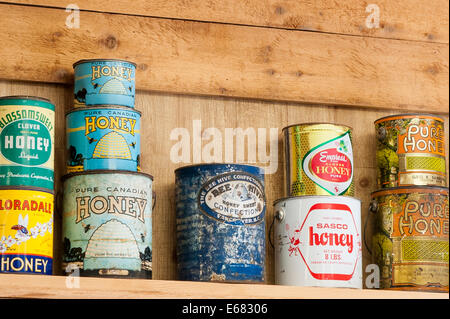 Antique vintage old honey cans at the Chilliwack River Valley Honey farm, Chilliwack, British Columbia, Canada. Stock Photo