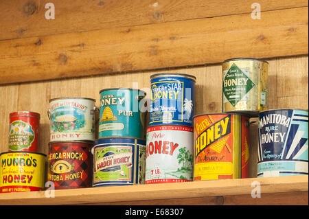 Antique vintage old honey cans at the Chilliwack River Valley Honey farm, Chilliwack, British Columbia, Canada. Stock Photo