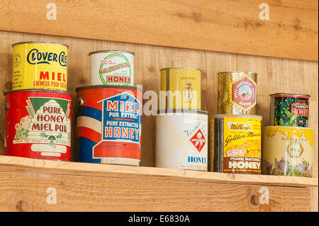 Antique vintage old honey cans at the Chilliwack River Valley Honey farm, Chilliwack, British Columbia, Canada. Stock Photo