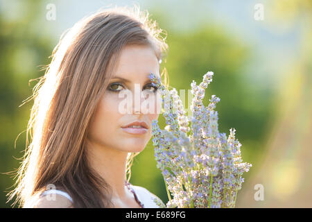 Beautiful young woman on lavender field - lavanda girl in early summer Stock Photo