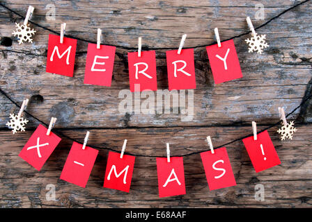 Red Tags Hanging on a Line with the Words Merry X-Mas on it, Christmas Background Stock Photo