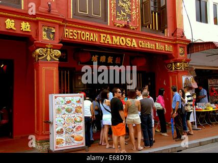 MELAKA, MALAYSIA: A crowd queues outside  famous Famosa Chicken Rice Ball Restaurant on Jonker Walk waiting for tables Stock Photo