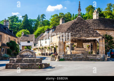 The 14th century market cross and mounting block in the picturesque Cotswold village of Castle Combe  in Wiltshire. Stock Photo