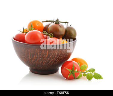 Different varieties of tomato in bowl isolated on white Stock Photo