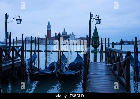 Early morning on the waterfront of Venice with gondolas looking toward the Church of San Giorgio Maggiore across the Lagoon. Stock Photo