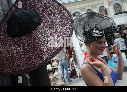 Moscow, Russia. 18th Aug, 2014. A visitor at the 12th International Specialized Exhibition of Headwear Raw Materials and Accessories 'Chapeau 2014', at Moscow's Gostiny Dvor. Credit:  Vyacheslav Prokofyev/ITAR-TASS/Alamy Live News