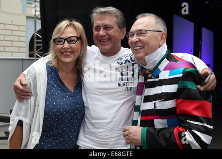 Moscow, Russia. 18th Aug, 2014. Actors Natalya Khorokhorina, Ivan Shabaltas and fashion designer Vyacheslav Zaitsev (L-R) pose for a photograph at the 12th International Specialized Exhibition of Headwear Raw Materials and Accessories 'Chapeau 2014', at M