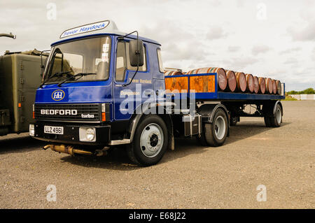 Bedford flat-bed  articulated lorry from the 1980s carrying whisky barrels from the Bushmills Distillery Stock Photo