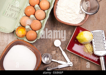 sponge cake ingredients eggs sugar flour lemon baking powder Stock Photo