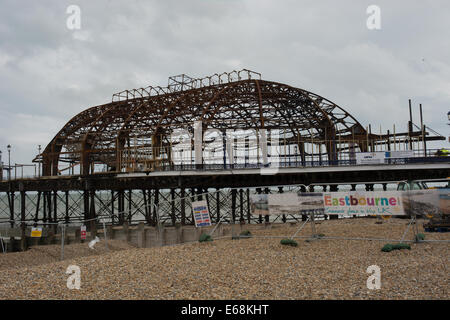 The damaged structure on Eastbourne pier is fenced off after a fire occured on the 31st July 2014. Stock Photo