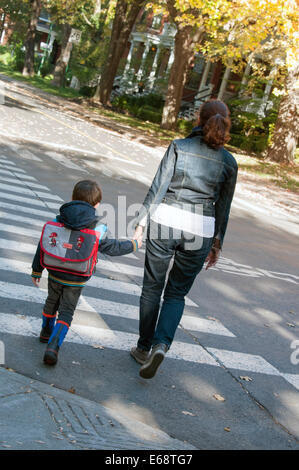 Adult and child walking to school Stock Photo