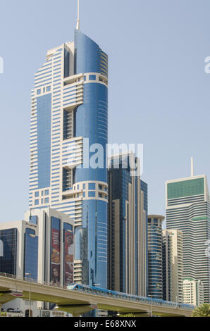 Dubai Metro train rapid transit and skyline of buildings office towers condos in Dubai, United Arab Emirates UAE. Stock Photo
