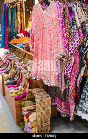 Clothes clothing shoes slippers and textiles at the Souk Madinat Jumeirah market Dubai, United Arab Emirates UAE. Stock Photo